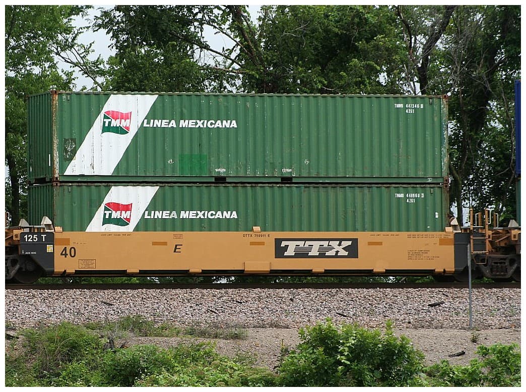 Containers riding directly on a rail car with no trailer wheels — container-on-flatcar (COFC).