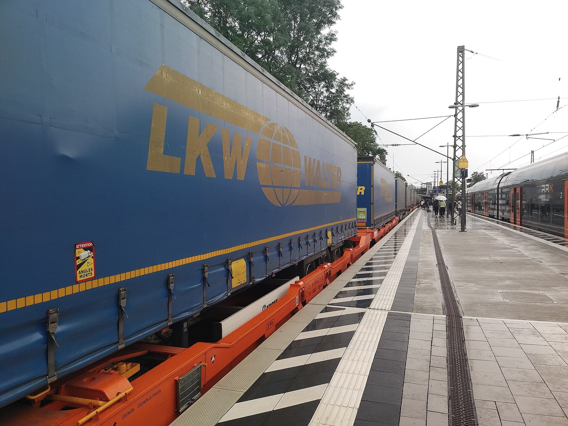 Truck trailers riding on rail flatcars — trailer-on-flatcar (TOFC) piggyback service.
